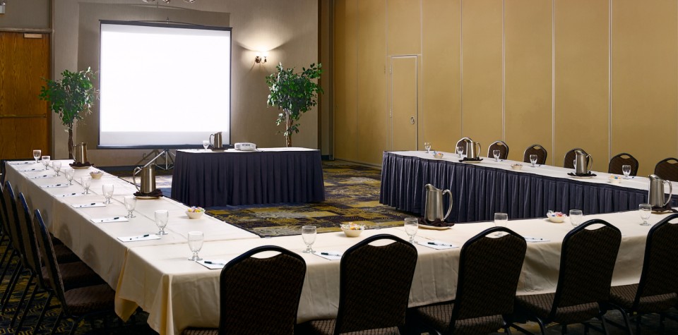 Conference Room Set Up in a U shape with screen and projector