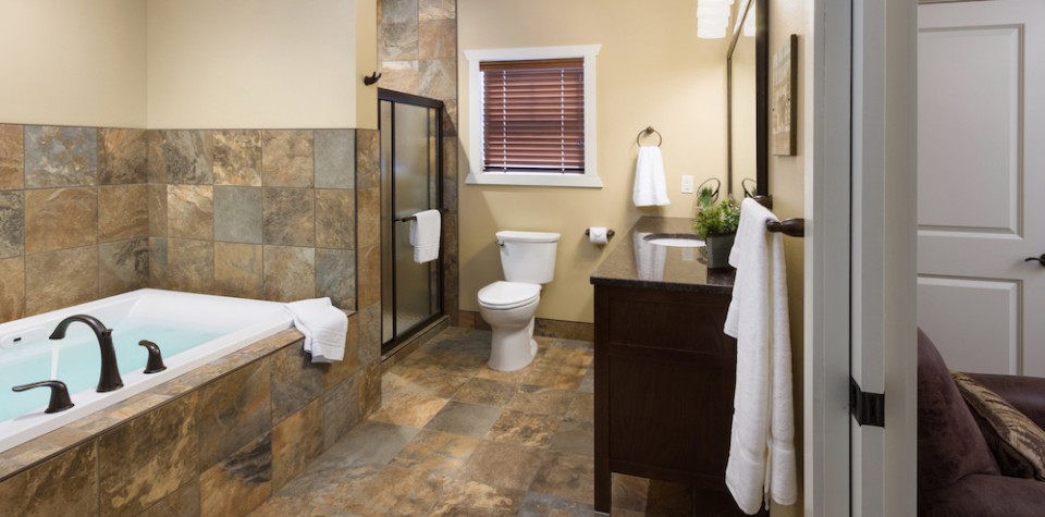 Large tub, separate shower, toilet, vanity, and towel racks