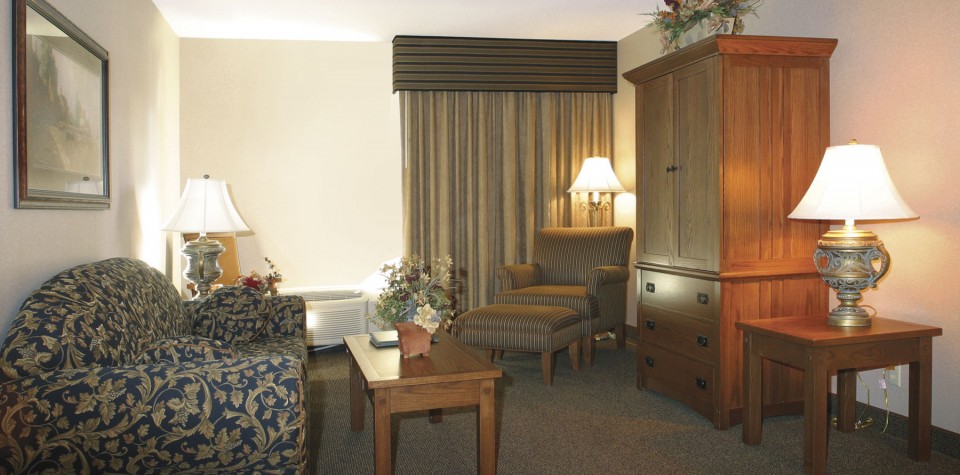 Sofa, coffee table, chair with footrest, armoire, and night stands